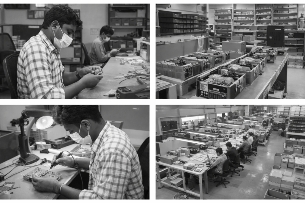 factory workers assembling electronics in masks